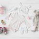 flatlay image of newborn layette baby clothing essentials