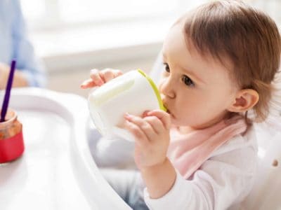 baby girl drinking from a non-toxic sippy cup