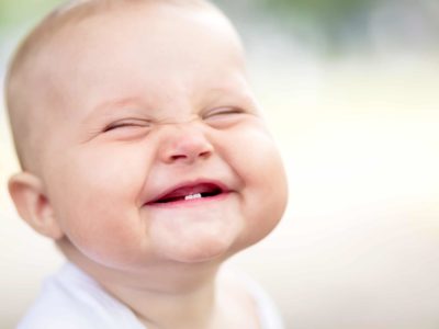 happy, smiling baby with two bottom teeth