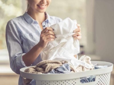 mom doing laundry with baby-safe laundry detergent