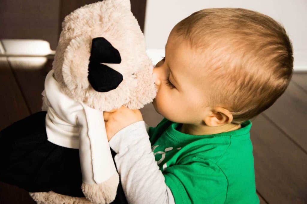 baby boy kissing a stuffed animal