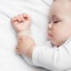 baby sleeping close-up in white pajamas