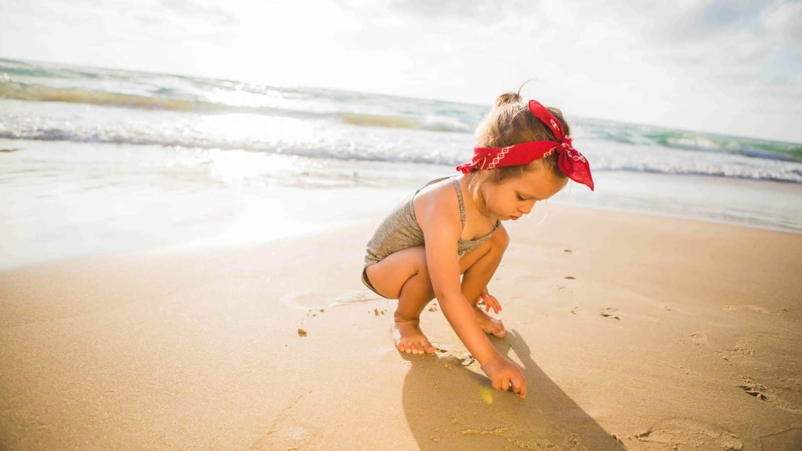 baby playing on the beach