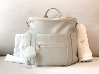 diaper bag with blanket, diapers, and other baby items inside