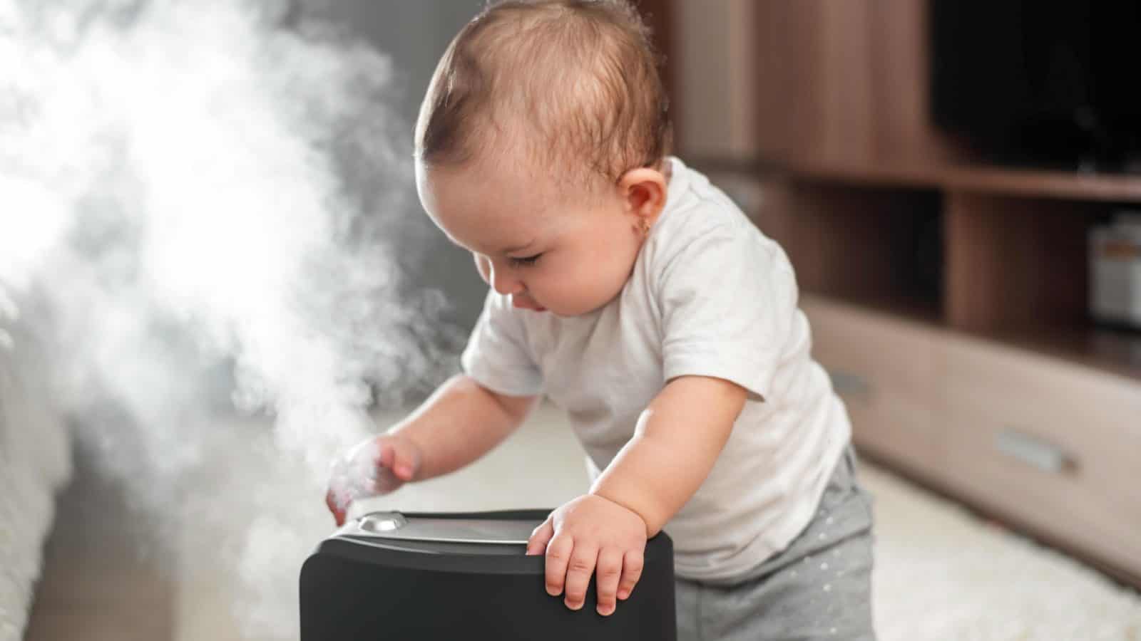 baby playing with humidifier
