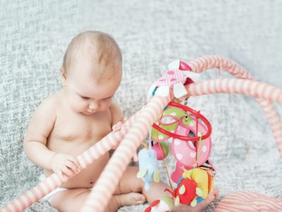 baby playing with play gym
