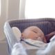 baby sleeping in travel bassinet