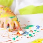 closeup of toddler painting with non-toxic paint