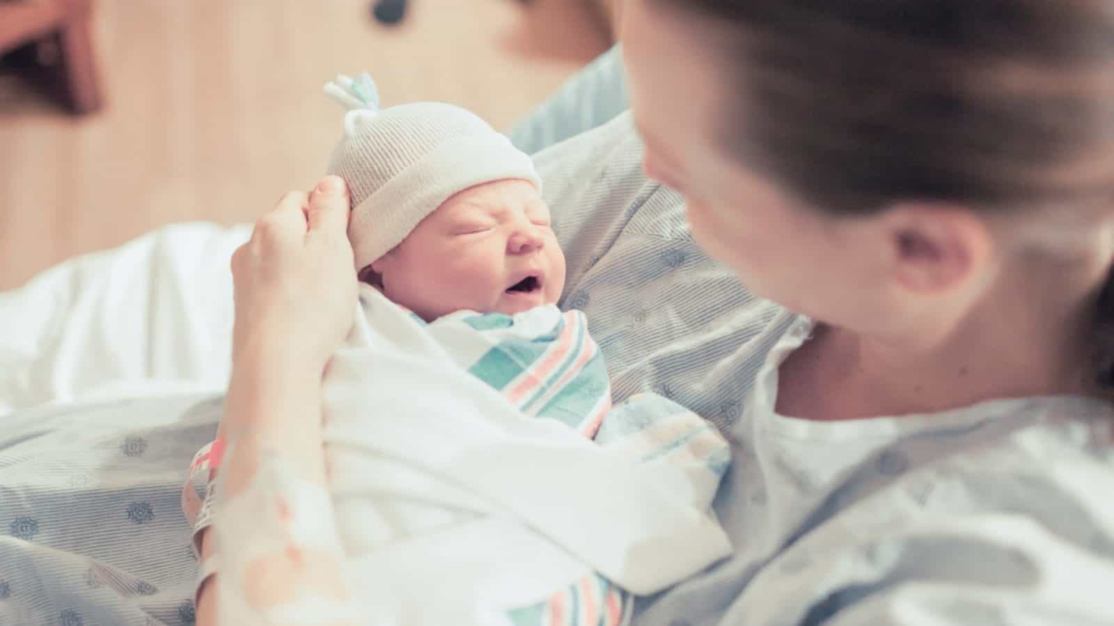 mom holding newborn baby after c-section