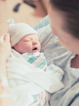 mom holding newborn baby after c-section