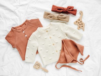 orange and cream organic baby clothes and wooden toys