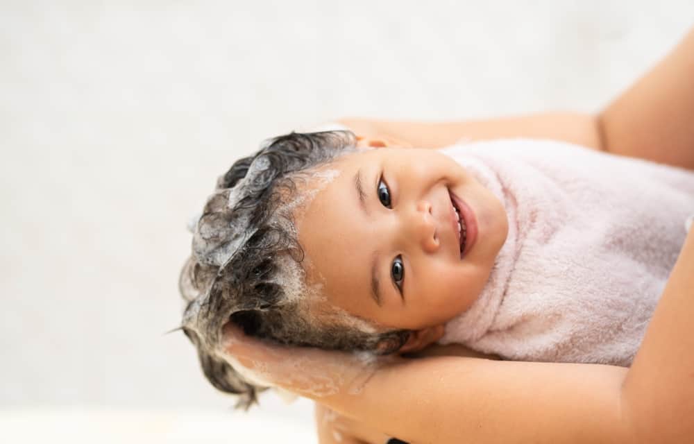 picture of cute happy baby with shampoo in hair