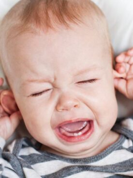 teething, crying baby pulling on ears