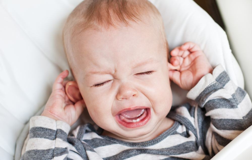teething, crying baby pulling on ears