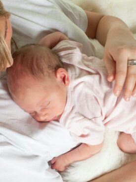 baby sleeping on mother's chest